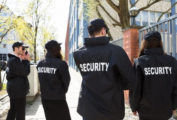 Security personnel monitoring a city street.